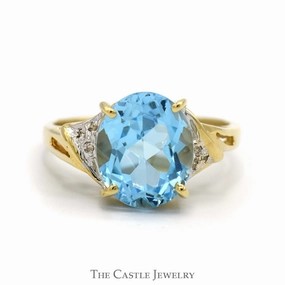 Meaningful Expression Oval Blue Topaz Ring with Diamond Accented Sides in 10k Yellow Gold