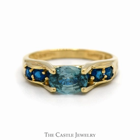 Brilliant Piece Inspiring Jewelry Oval Blue Zircon Ring with Blue Topaz Sides in 14k Yellow Gold Bridge Designed Mounting
