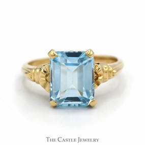 Vintage Emblem Portable Size Emerald Cut Blue Topaz Ring with Textured Sides in 10k Yellow Gold