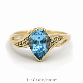 Neutral Tone Understated Elegance Pear Shaped Blue Topaz Ring with Illusion Set Diamond Accents in 10k Yellow Gold