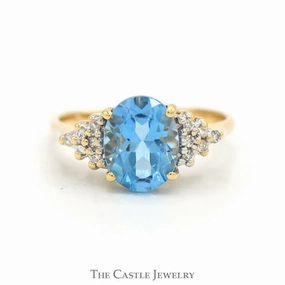 Oval Cut Blue Topaz Ring with Diamond Cluster Accented Sides in 14k Yellow Gold Classic Keepsake