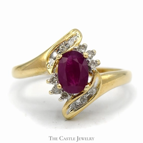 Superior Adornment Oval Ruby Bypass Ring with Diamond Accent in 10k Yellow Gold