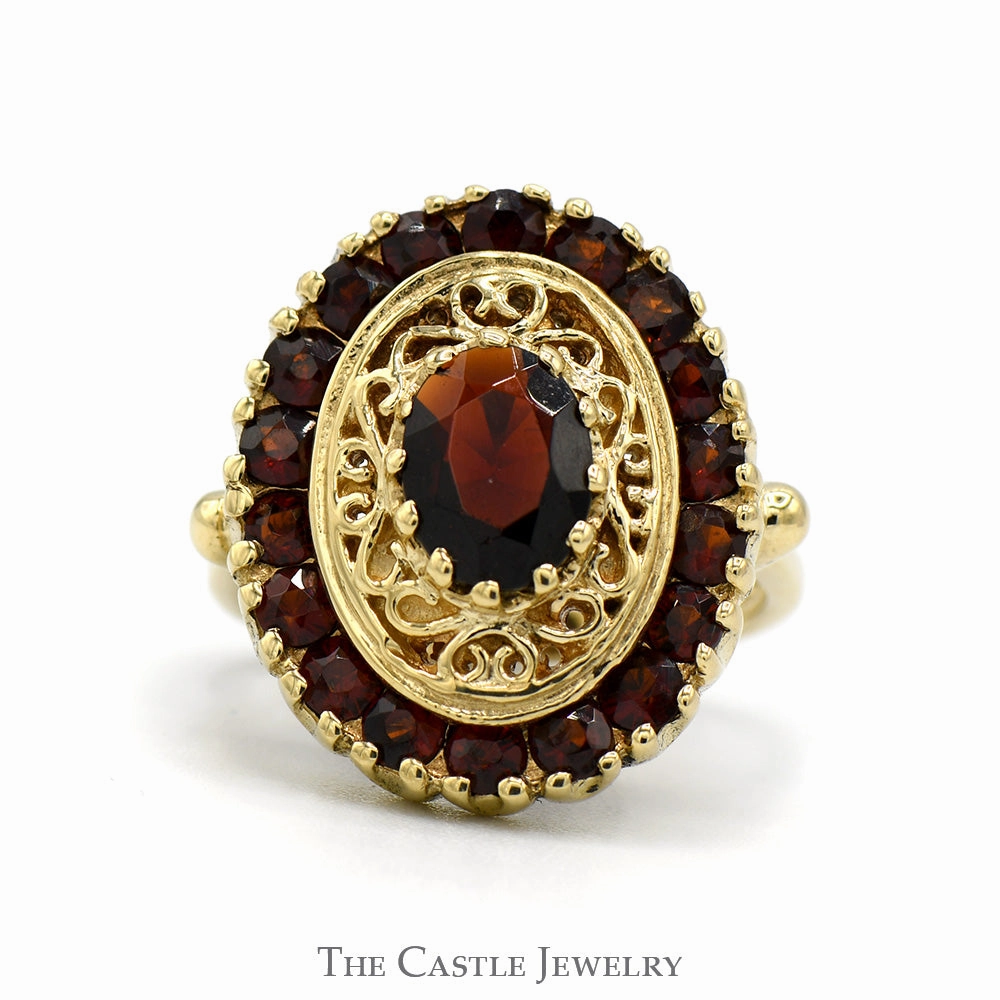 Oval Cut Garnet Shield Ring with Garnet Halo and Open Filigree Design in 10k Yellow Gold Brilliant Product