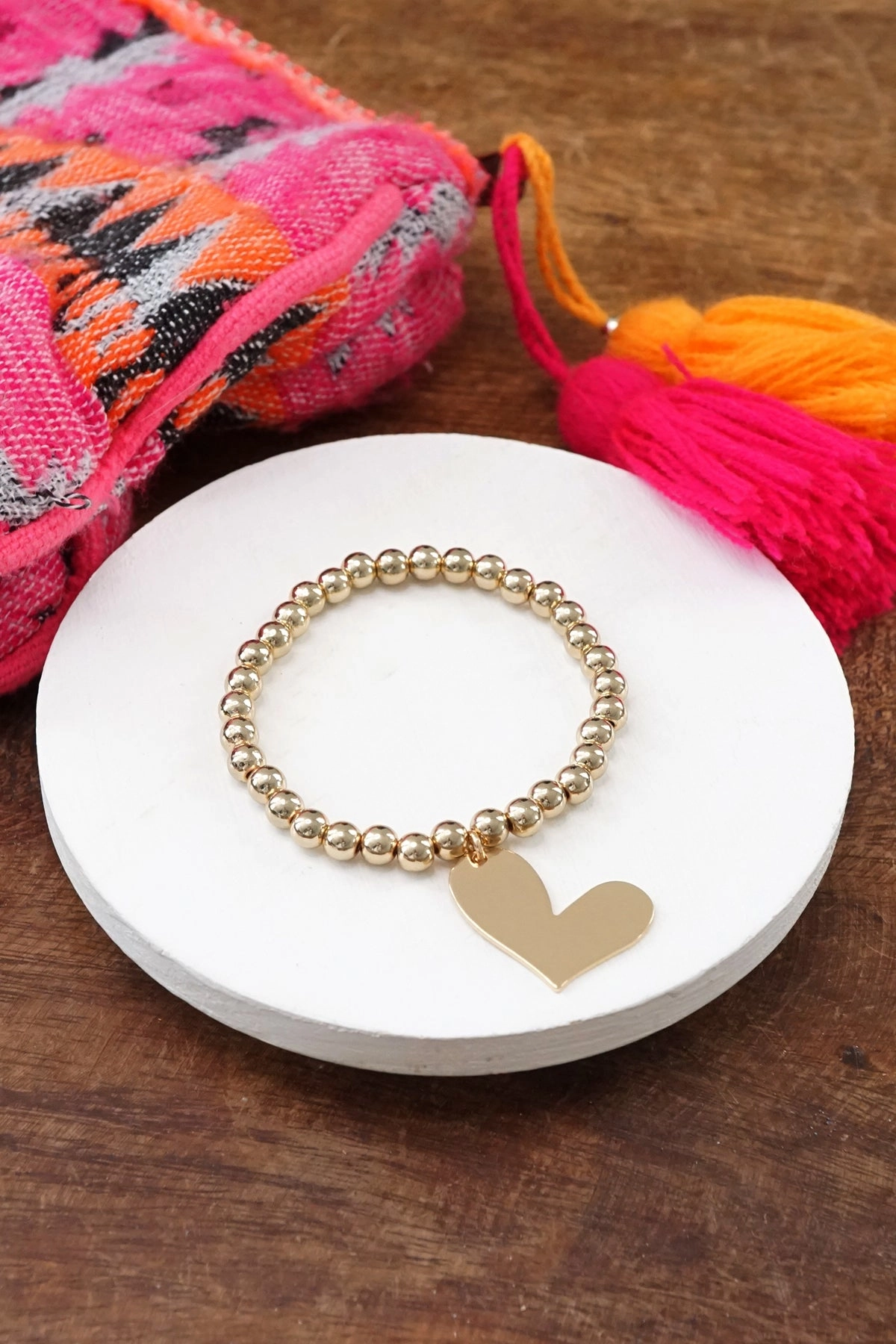 Design Narrative Gold tone beads bracelet with a big Heart charm