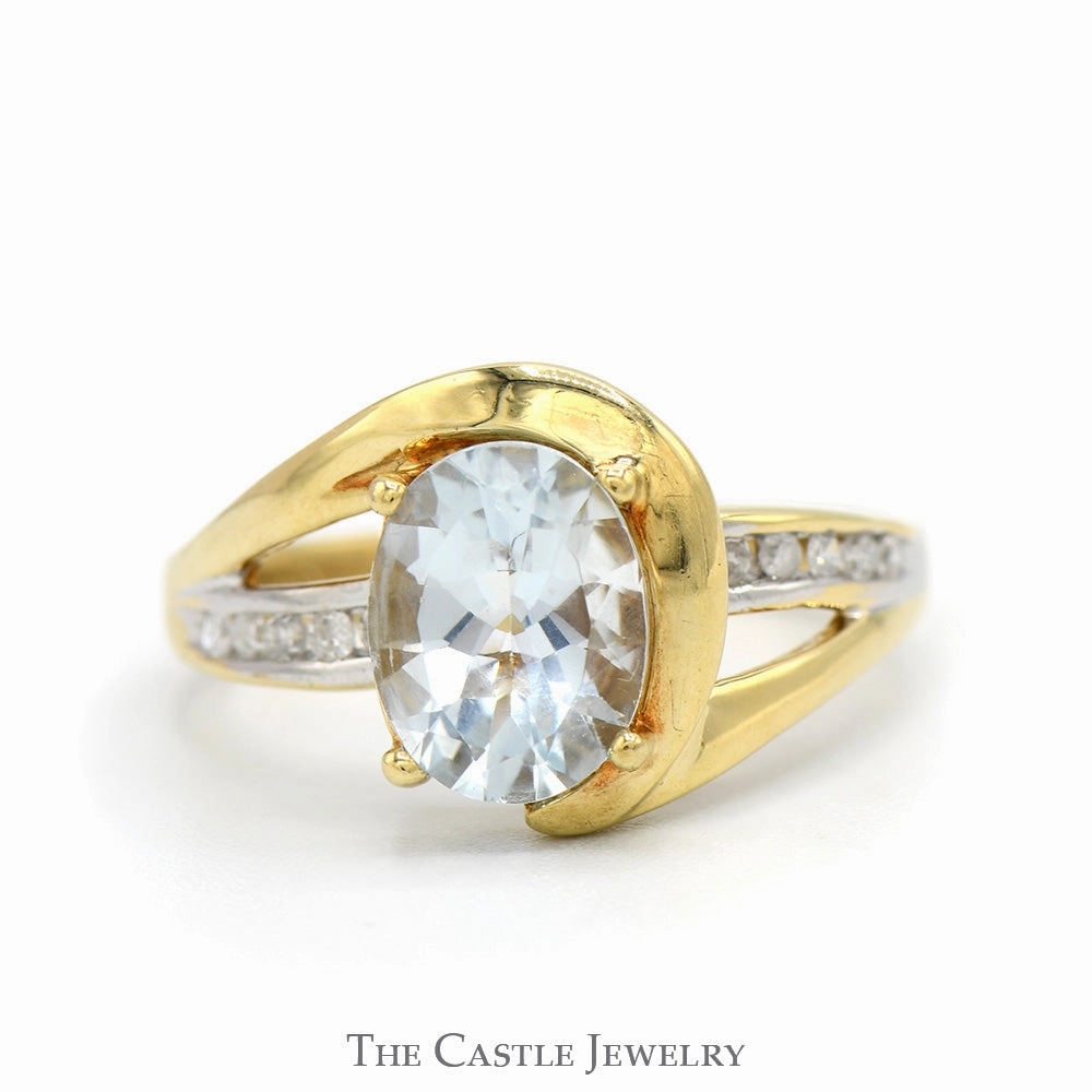 Signature Accessory Oval Cut Aquamarine Ring with Channel Set Diamond Accented Sides in 10k Yellow Gold Swirled Bypass Mounting